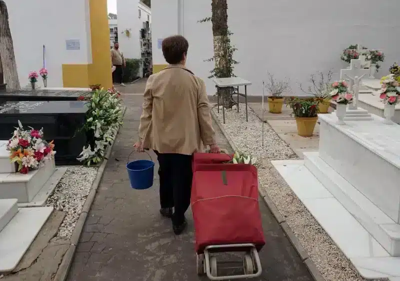 Archivo - Una persona visita y arregla una tumba en el cementerio de la barriada de El Palo en el Día de Todos los Santos. - Álex Zea - Europa Press - Archivo